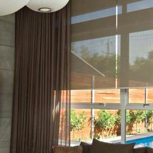 Living room featuring Designed Blinds Australia Logic rollers and sheer curtain Motorised Roller Blinds